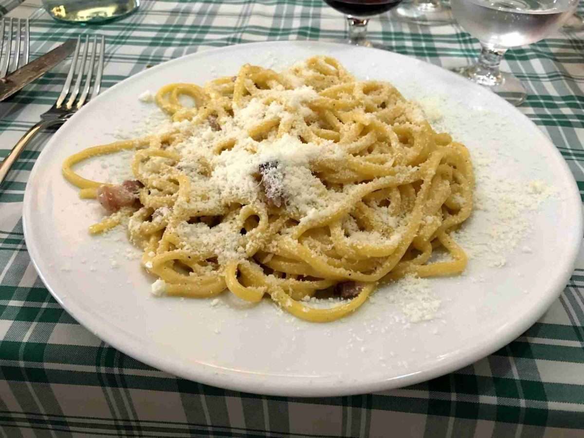 caccio e pepe gricia amatriciana carbonara roma a plate of pasta with a lot of grated cheese on top