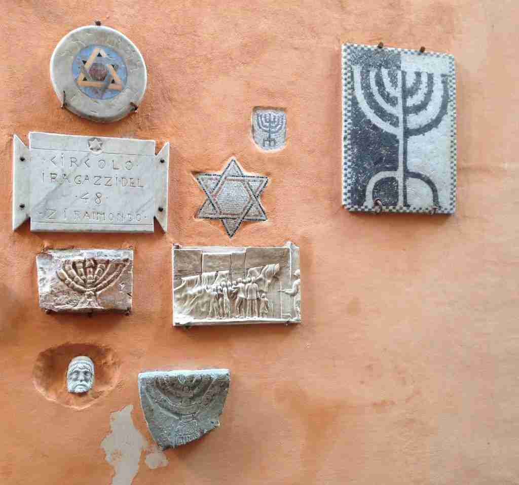 Commemorative plaques on a wall in Rome's Jewish Quarter