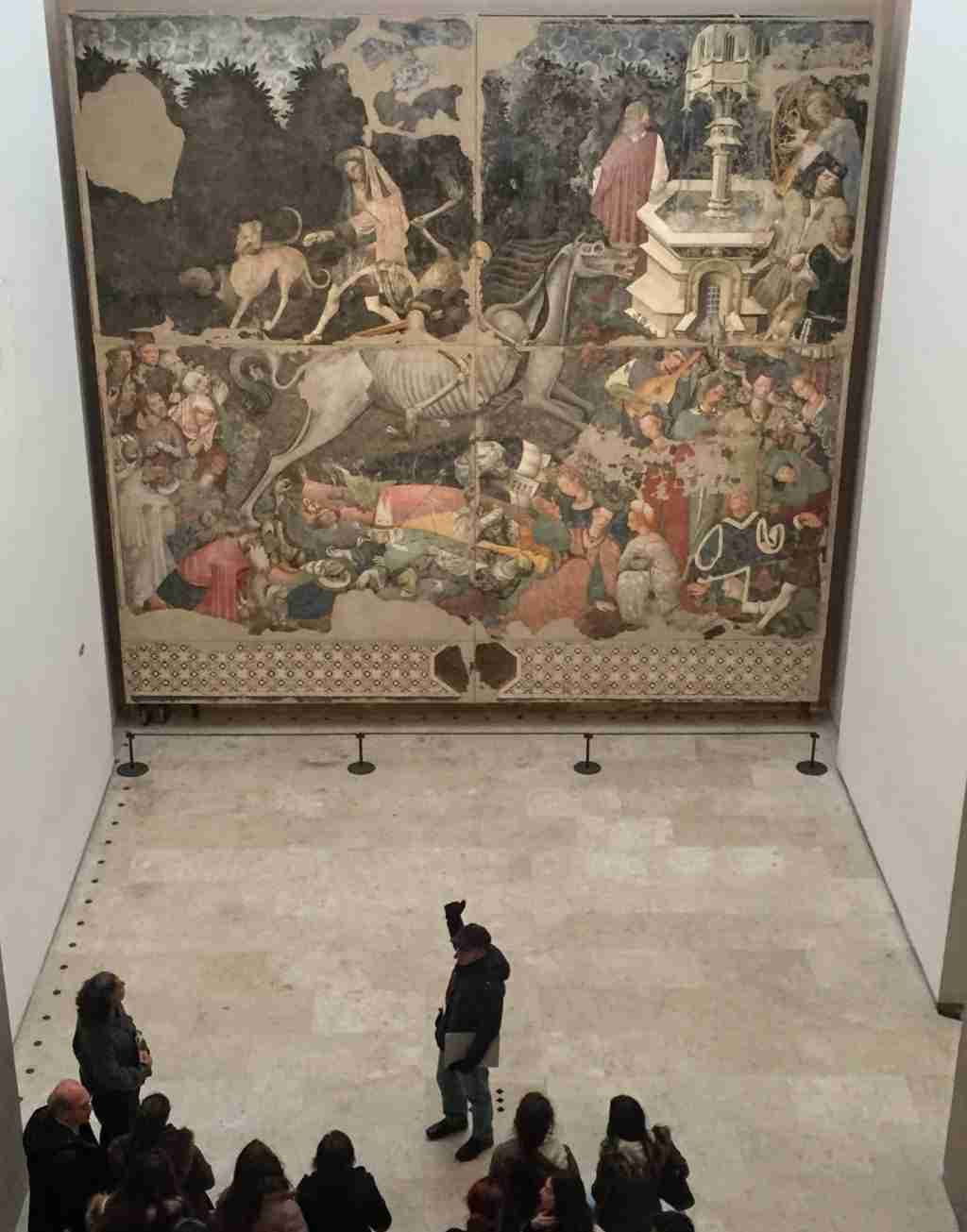 Triumph of Death, Palermo. Photo shows scale of painting next to tour group.