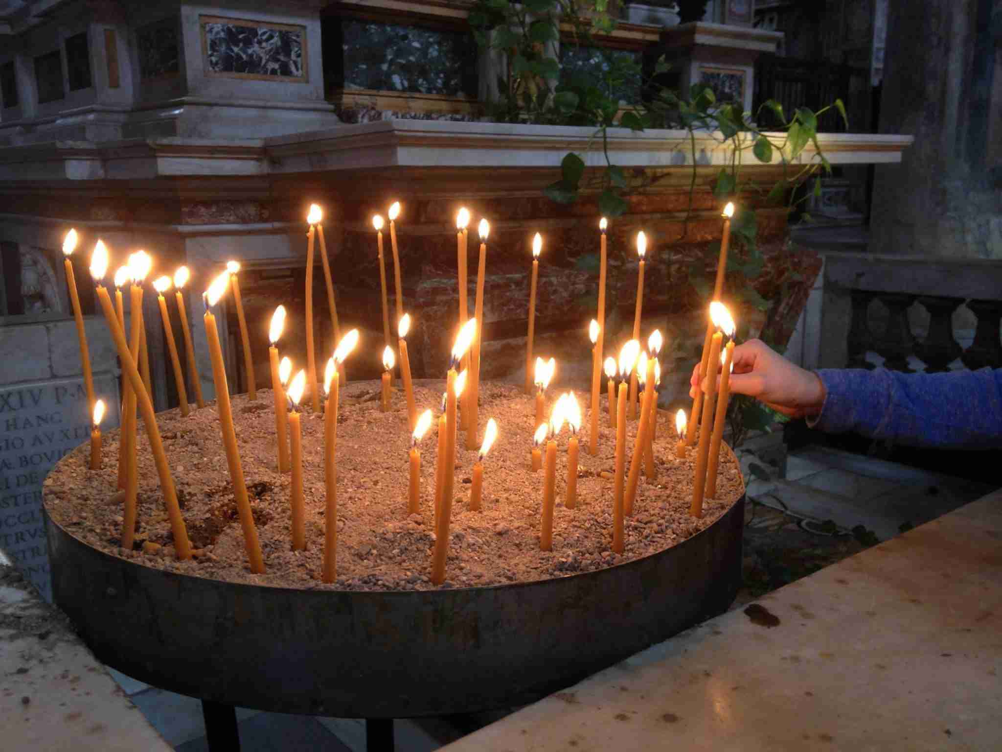 Lighting candles at a church in Rome